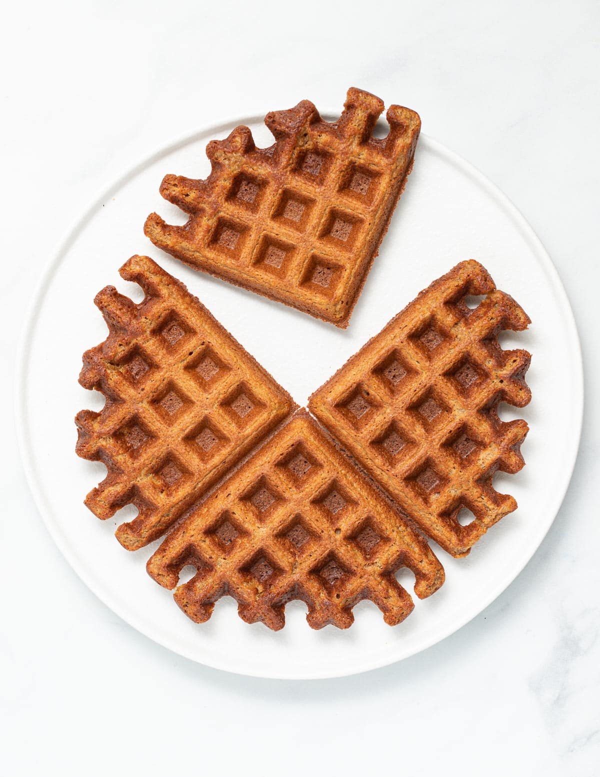 4 waffles on a white plate