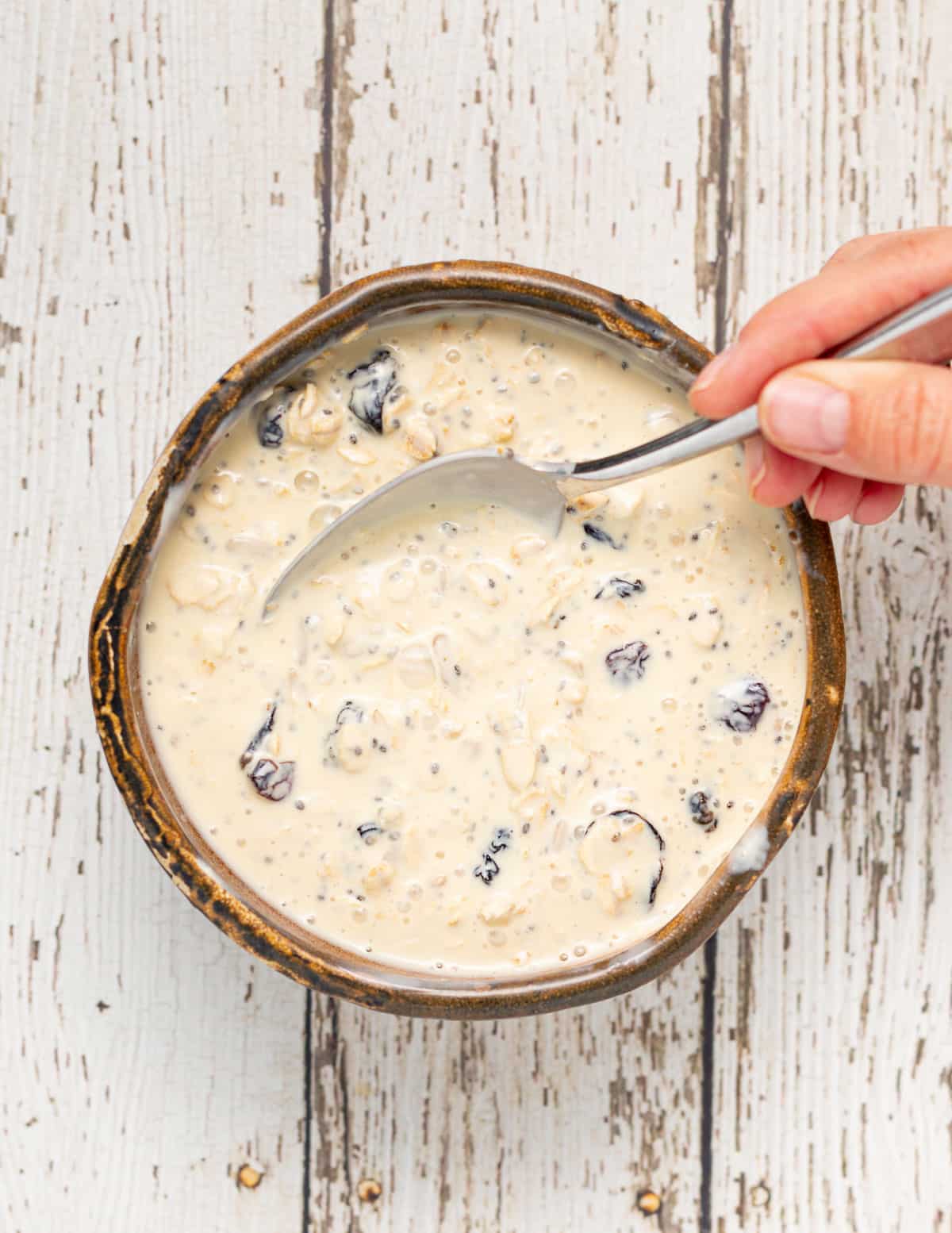 milky oats in a bowl being stirred