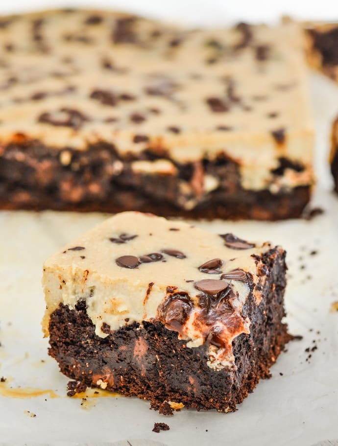 Cheesecake Topped Vegan Brownies. An individual square with a whole slab in the background. 