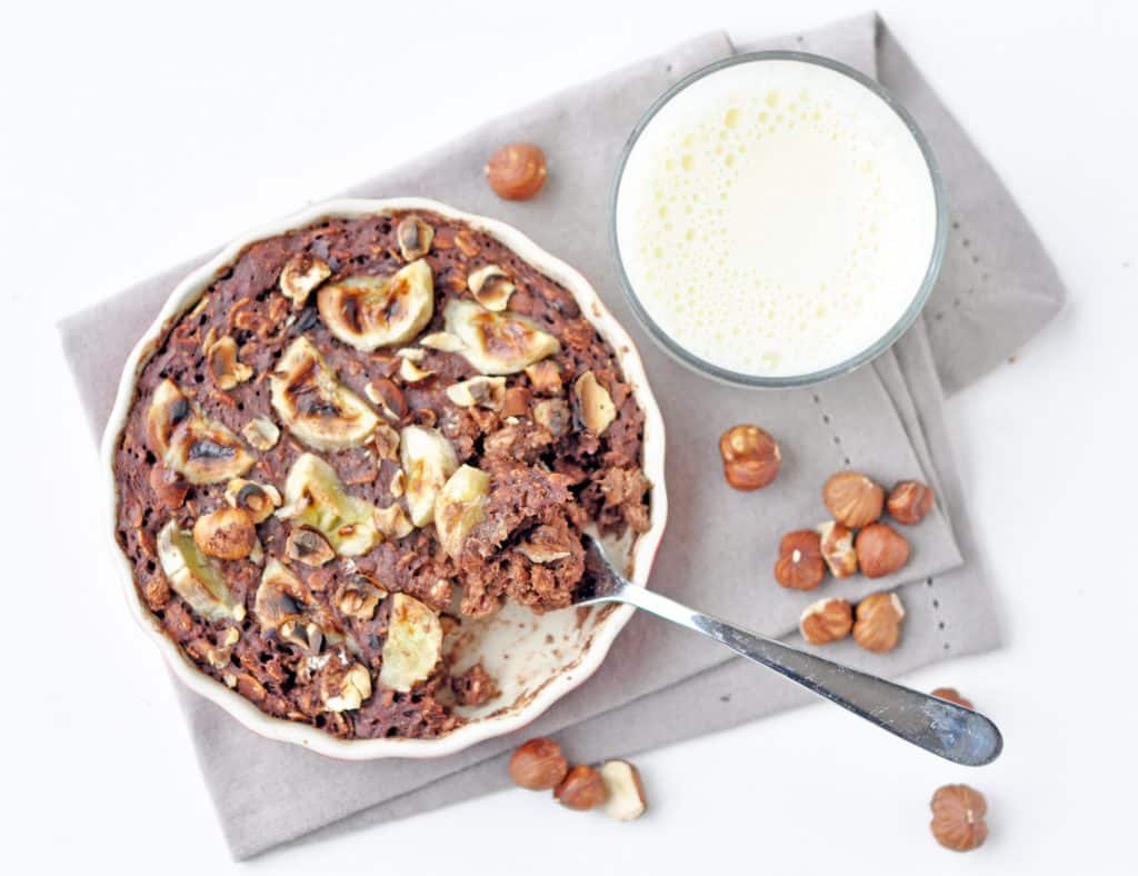 A mouthwatering Chocolate Banana Hazelnut Baked Oatmeal with a deliciously crusty exterior and a soft, creamy, chocolatey oaty interior, crunchy roasted hazelnuts and soft, sweet baked banana.