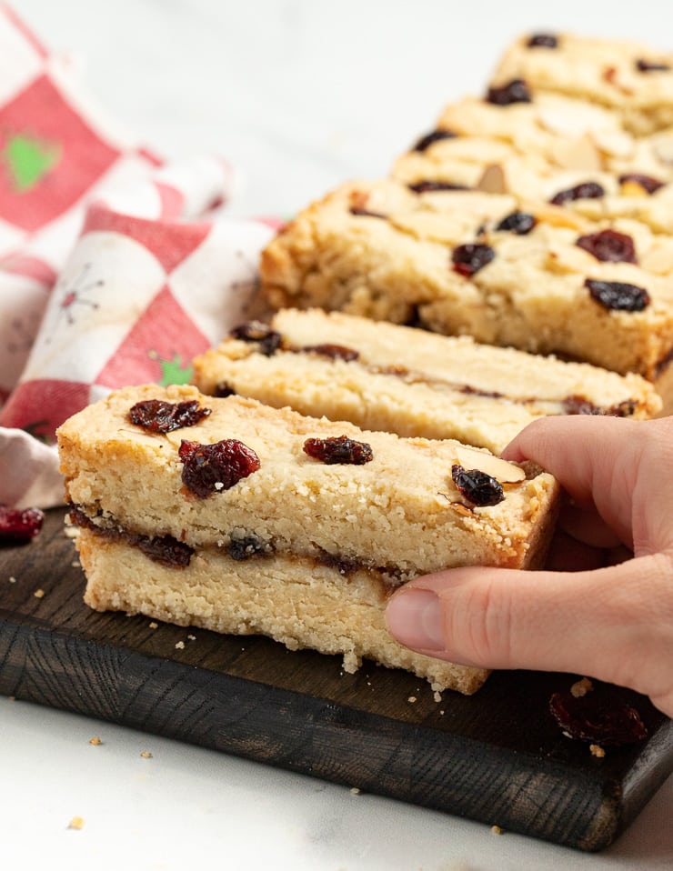 a hand taking a piece of Christmas shortbread