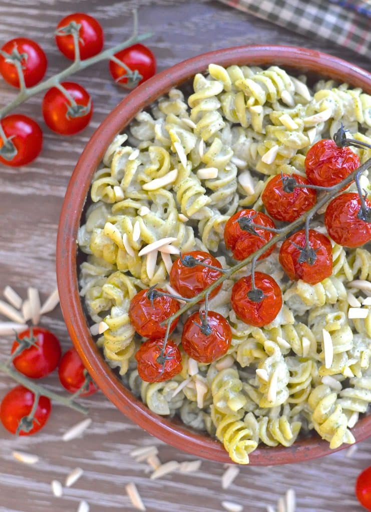 Vegan Mother's Day recipes - A simple but incredibly delicious, super creamy Vegan Pesto Pasta Salad topped with juicy, sweet, oven roasted tomatoes. It has just 5 ingredients & is ready in the time it takes to roast the tomatoes!