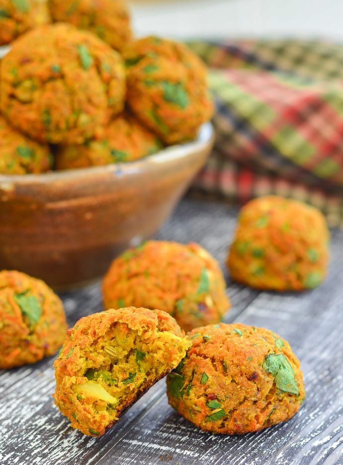 Inside shot of Curried Carrot Baked Falafel with bowl of falafel in background