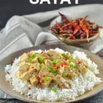 a plate of tofu satay over rice