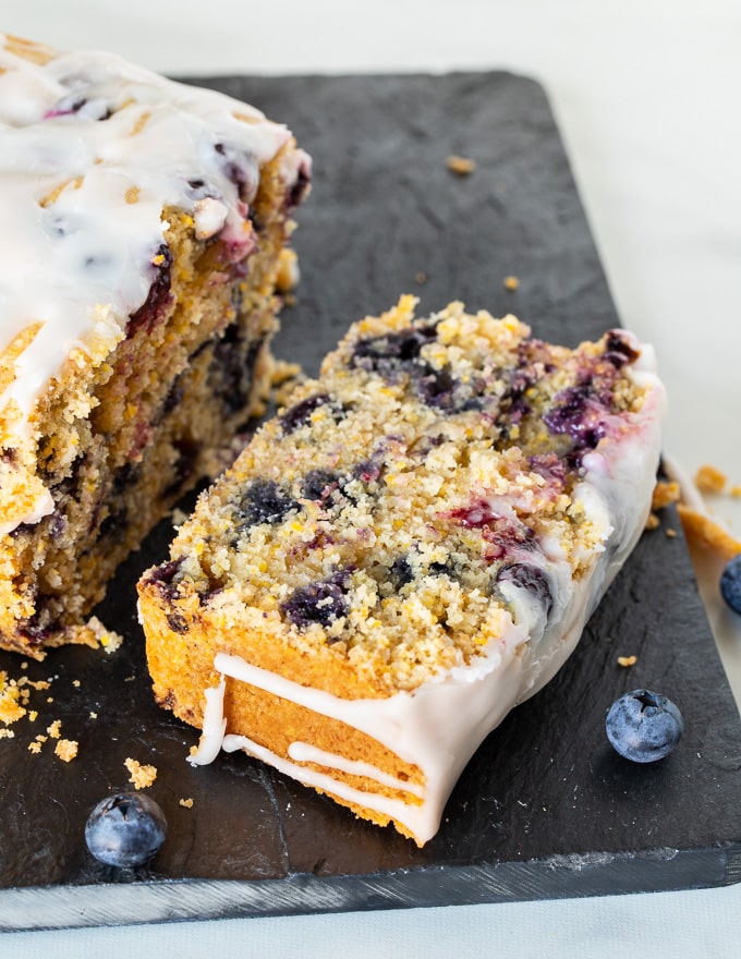 a slice of gluten-free lemon cake on a slate cutting board