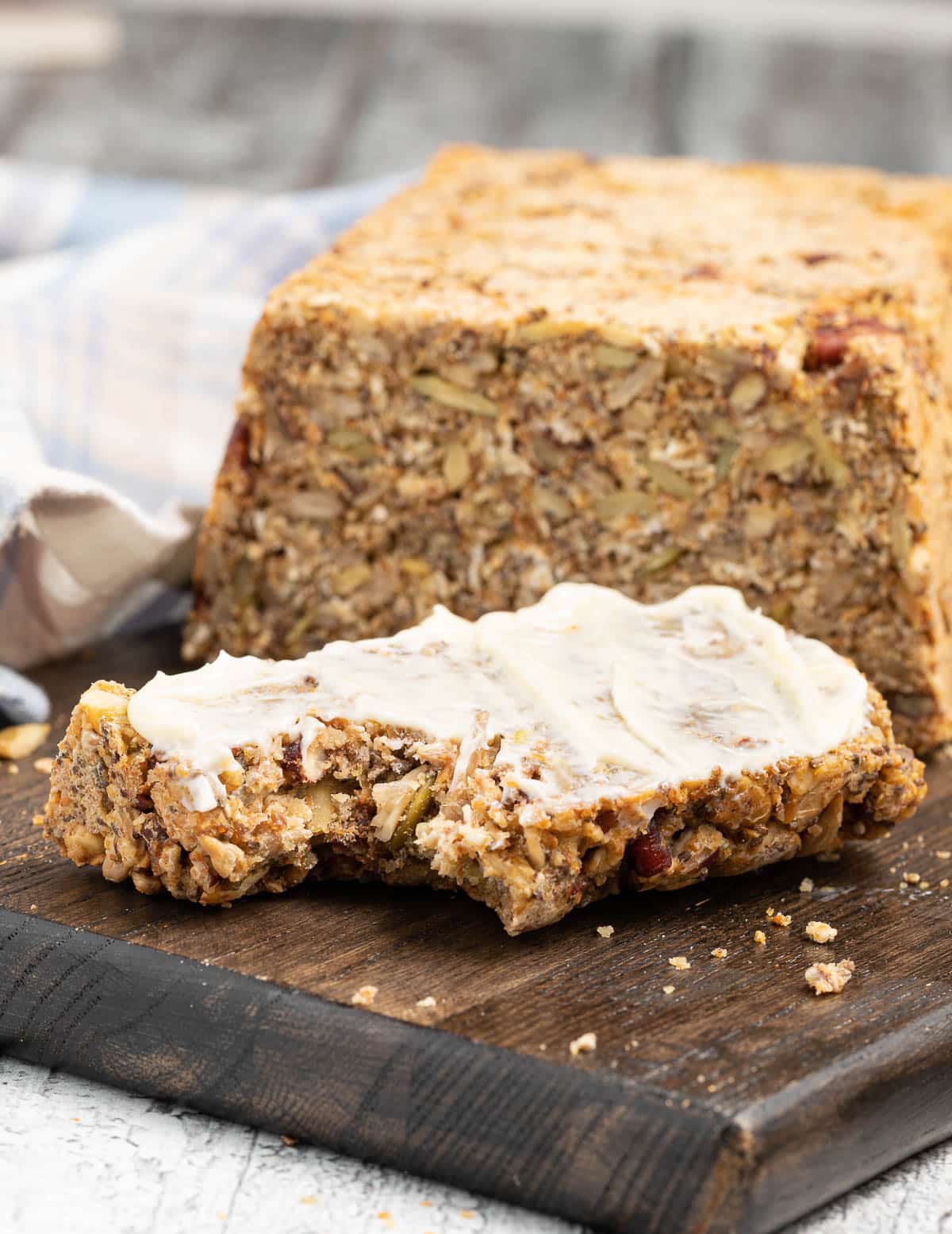 a slice of gluten-free seed bread with a bite taken out