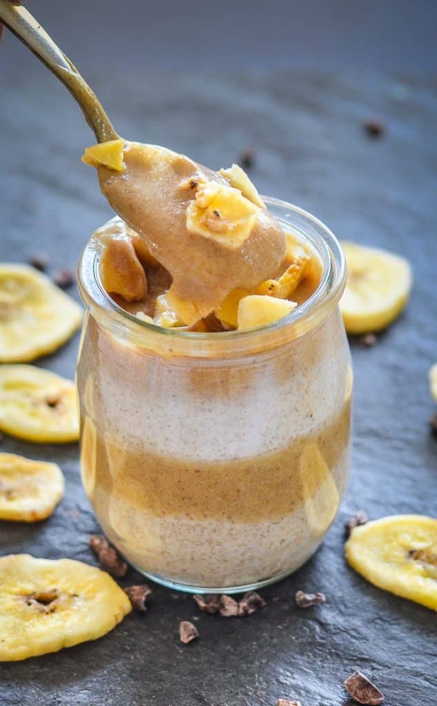 chia seed pudding with caramel being spooned out of a small jar