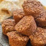 A pile of Healthy Carrot Muffins on a decorative metal platter