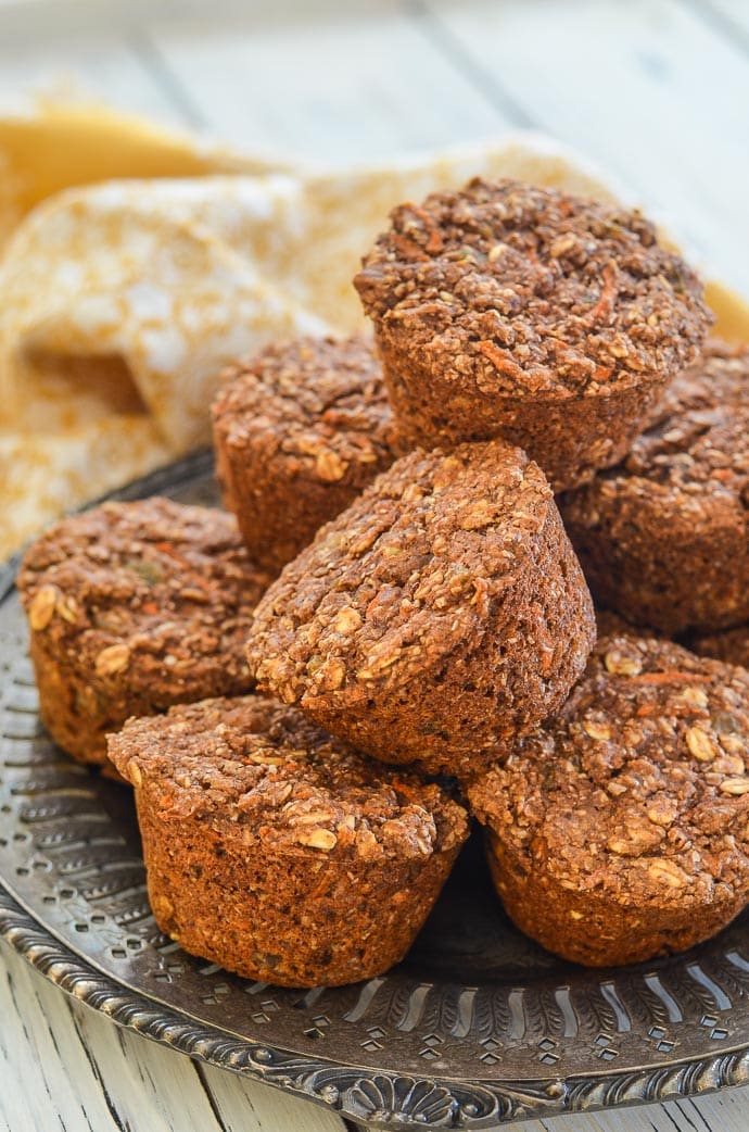 A pile of Healthy Carrot Muffins on a decorative metal platter