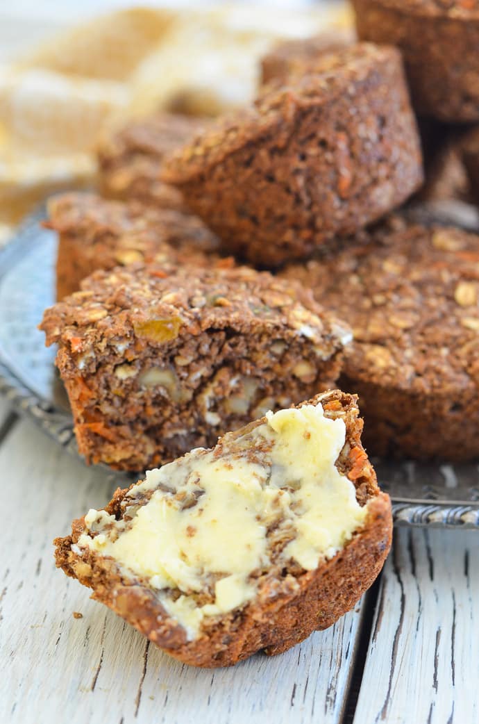 A Healthy Carrot Muffin, cut in half. One side spread with butter