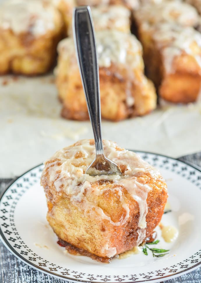 A piece of No Knead Cinnamon Pull Apart Bread on a plate with a fork stuck in the top