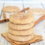 A stack of Perfect Vegan Snickerdoodles with cinnamon sticks in the background