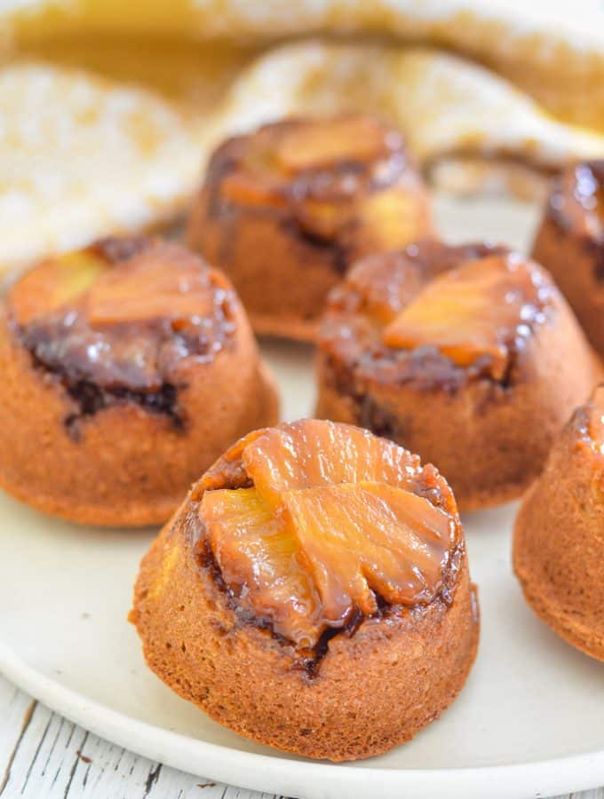 pineapple upside down cupcakes with glistening pineapple bottoms