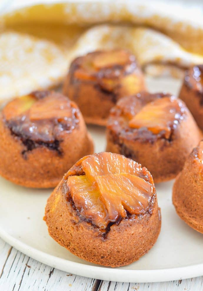 pineapple upside down cupcakes with glistening pineapple bottoms