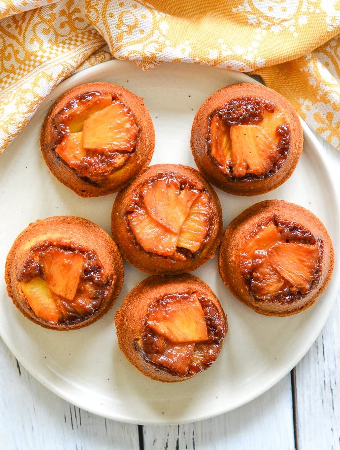 pineapple upside down cupcakes turned out of pan and arranged on a platter