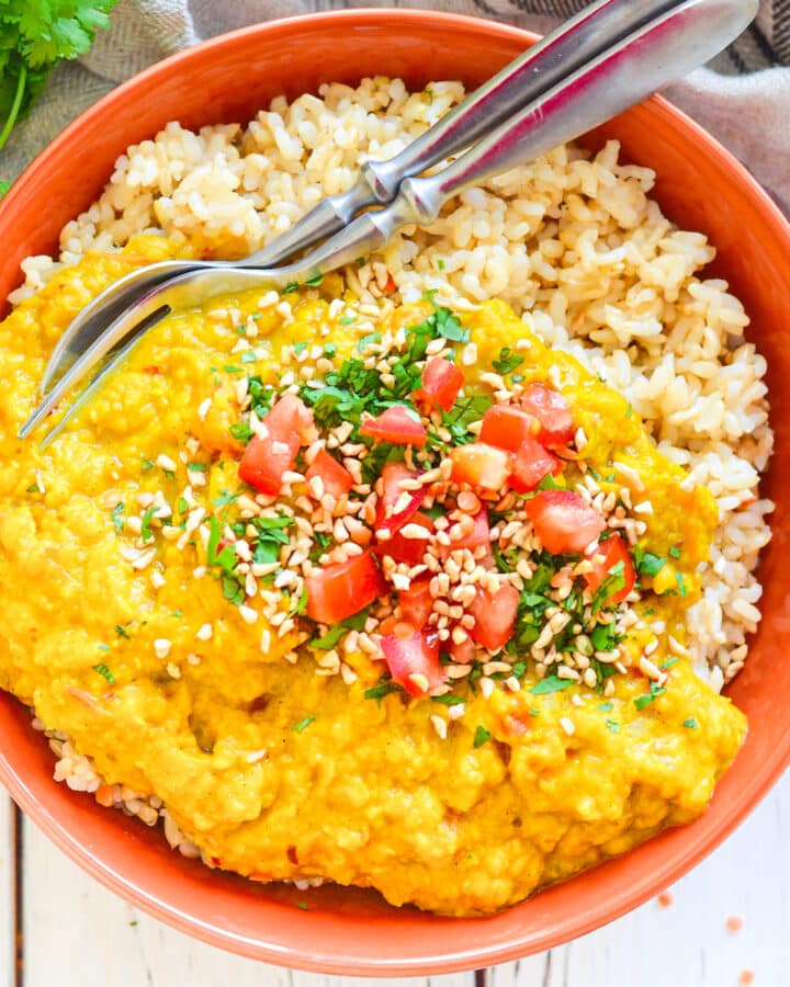 Red Lentil Dahl over rice in a bowl