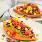 Sweet Potato Breakfast Boat from the side on a plate with another in background