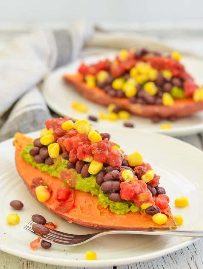 Sweet Potato Breakfast Boat from the side on a plate with another in background