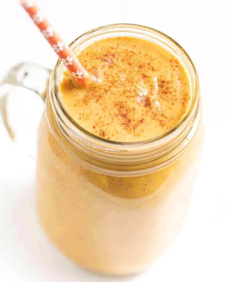 sweet potato smoothie with an orange flowery straw