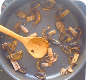 mushrooms sautéing in a pan - making udon noodle soup