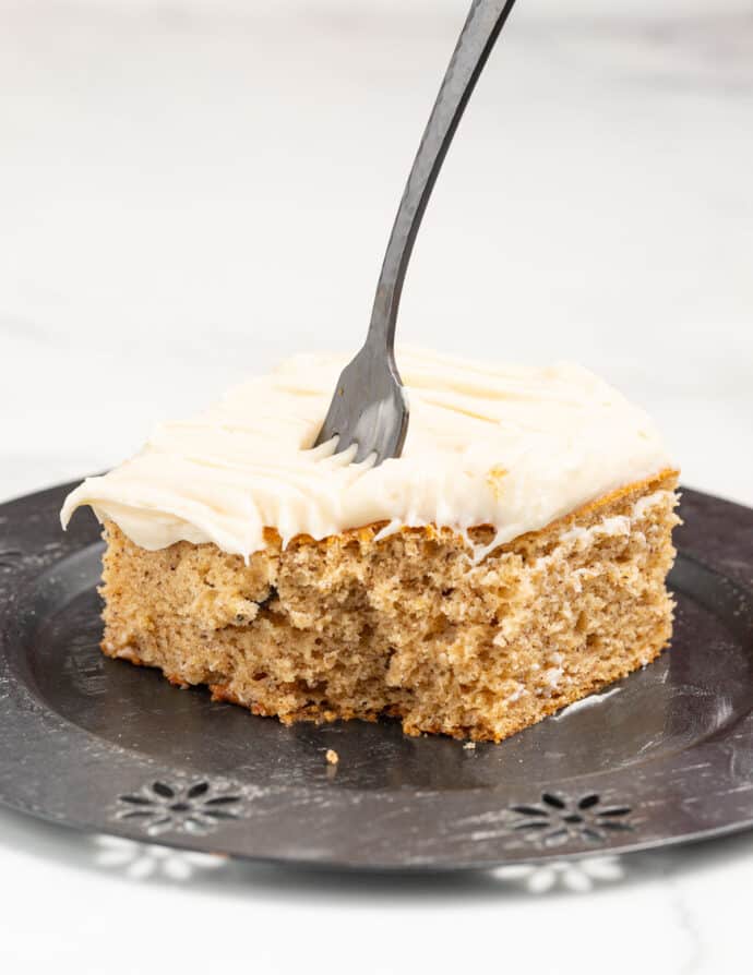 a piece of cake with a bite taken out of it and a fork stuck in it