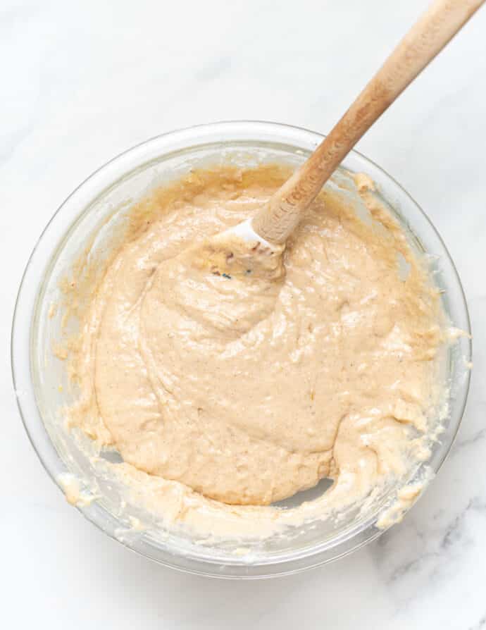 cake batter in a glass bowl with a spatula