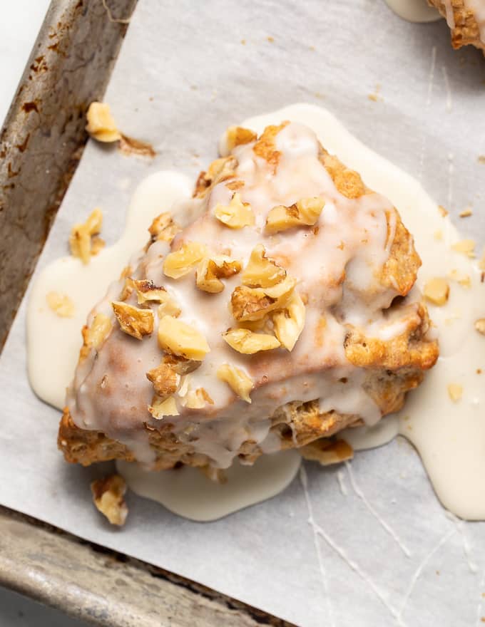 a close up shot of a vegan banana scone with glaze from above