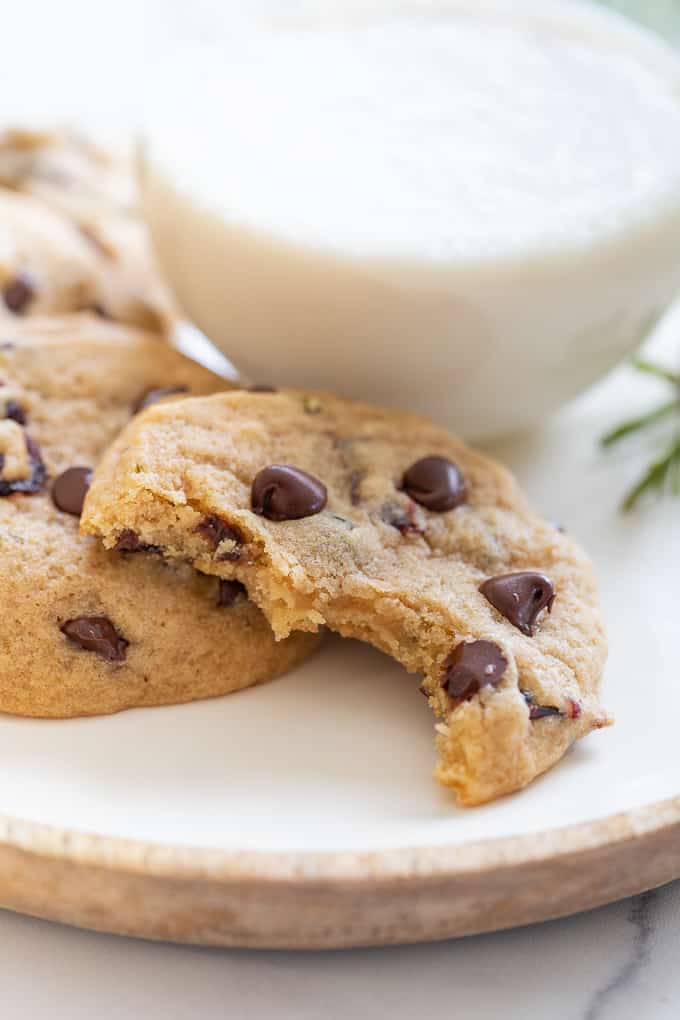 Part eaten vegan chocolate chip cookie on a plate 