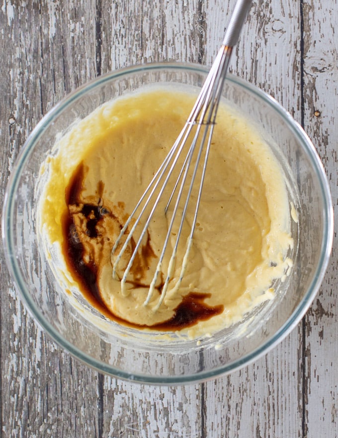 Vegan Gluten Free Pancakes batter in a bowl with vanilla extract about to be mixed in