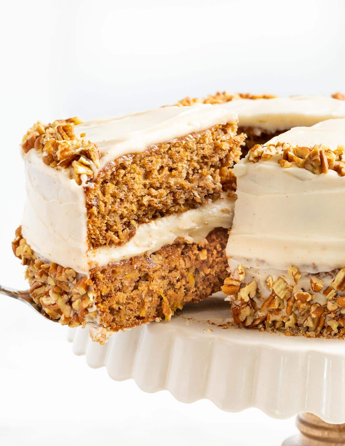 a slice of vegan hummingbird cake being cut