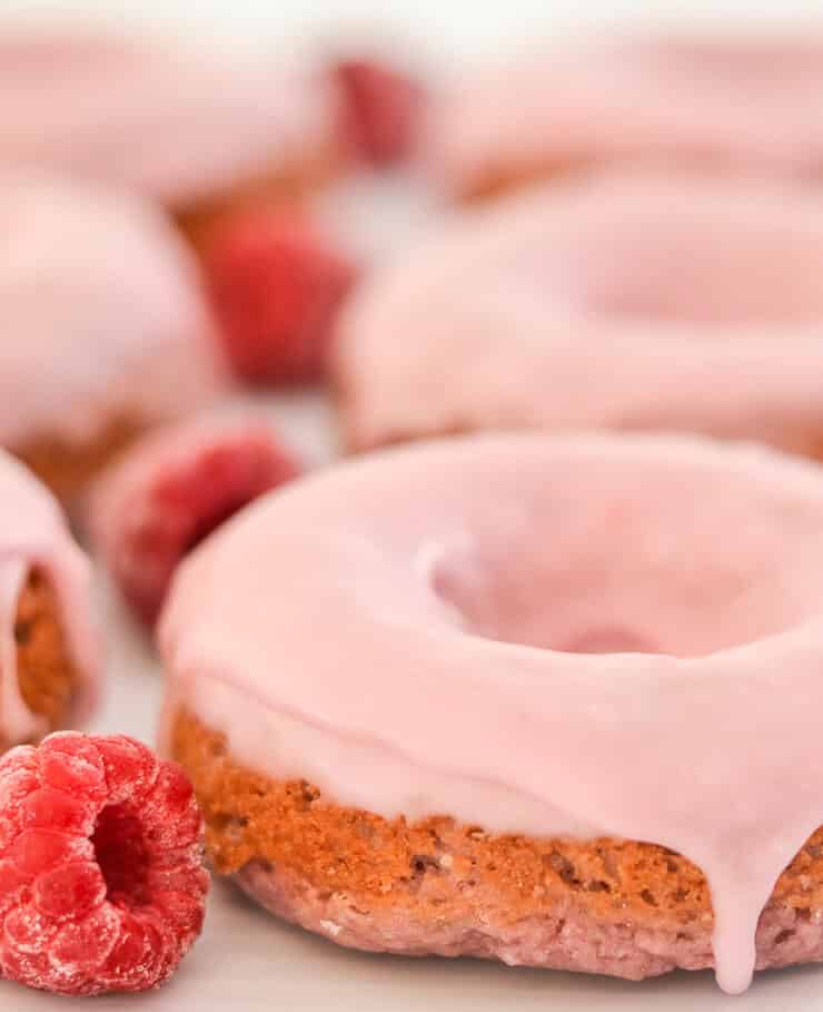 Soft & fluffy baked Vegan Raspberry Donuts with a sweet, smooth, pretty in pink glaze. All infused with sweet raspberry flavour & so delicious! Don't worry if you don't have a donut pan because they can also be made as muffins.