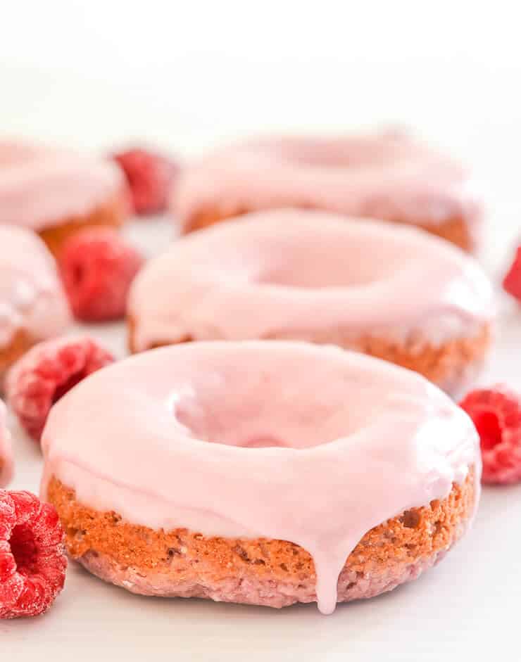 Vegan Mother's Day recipes - Soft & fluffy baked Vegan Raspberry Donuts with a sweet, smooth, pretty in pink glaze. All infused with sweet raspberry flavour & so delicious! Don't worry if you don't have a donut pan because they can also be made as muffins.