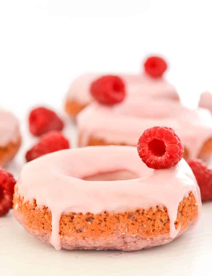 Soft & fluffy baked Vegan Raspberry Donuts with a sweet, smooth, pretty in pink glaze. All infused with sweet raspberry flavour & so delicious! Don't worry if you don't have a donut pan because they can also be made as muffins.