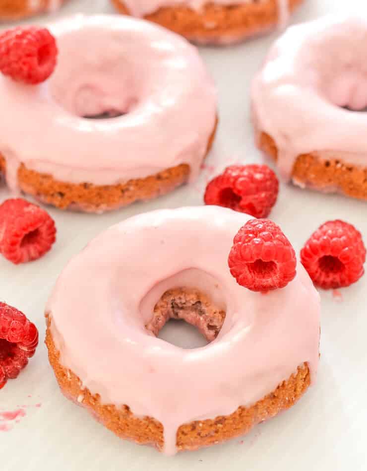 Soft & fluffy baked Vegan Raspberry Donuts with a sweet, smooth, pretty in pink glaze. All infused with sweet raspberry flavour & so delicious! Don't worry if you don't have a donut pan because they can also be made as muffins.