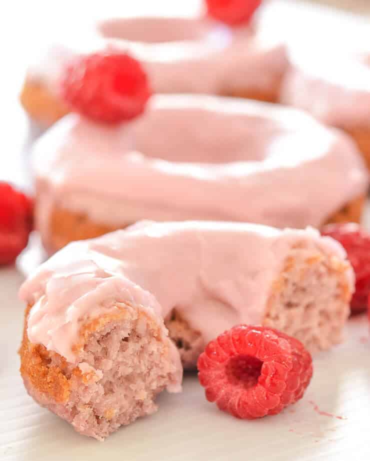 Soft & fluffy baked Vegan Raspberry Donuts with a sweet, smooth, pretty in pink glaze. All infused with sweet raspberry flavour & so delicious! Don't worry if you don't have a donut pan because they can also be made as muffins.