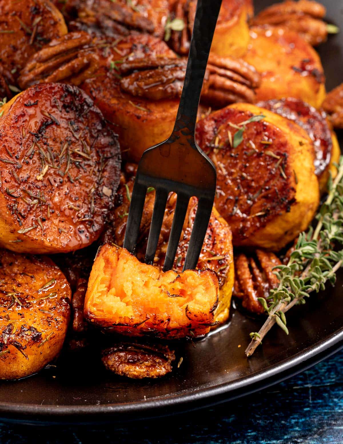 half a sweet potato chunk on a fork showing the inside