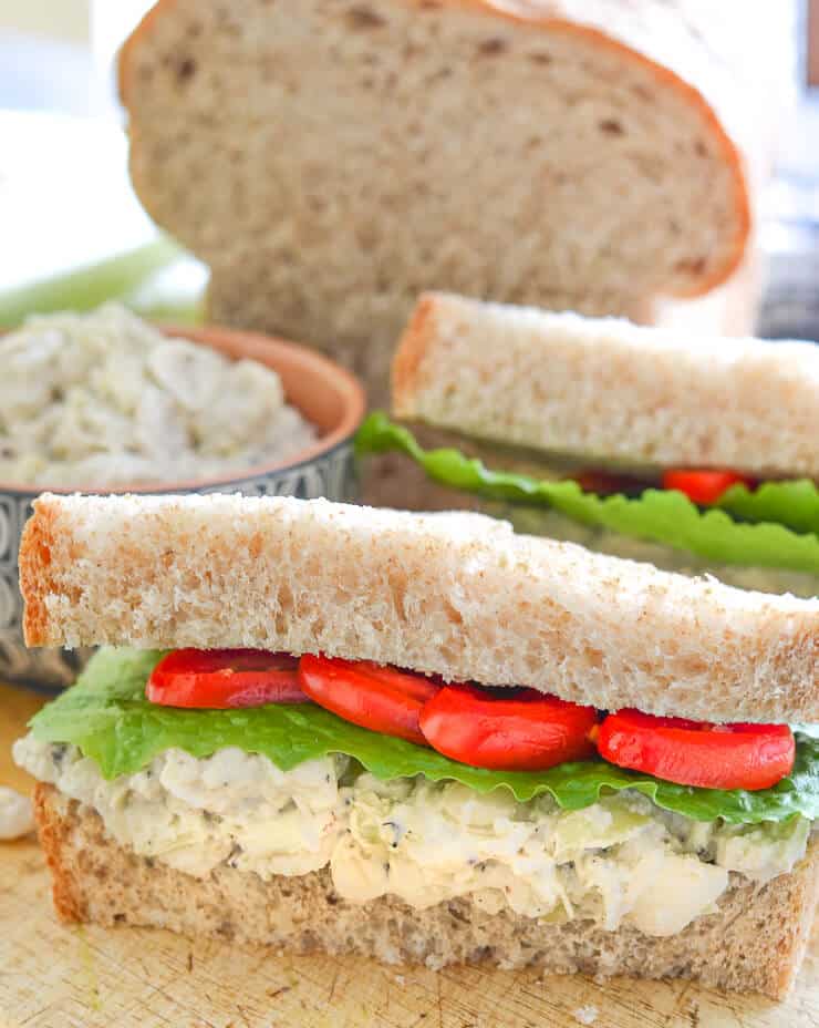 Tuck a napkin into your collar because you're gonna need it when you bite into a big, thick doorstep of a sandwich stuffed to bursting with this creamy Smashed White Bean & Artichoke Vegan Sandwich Filling!